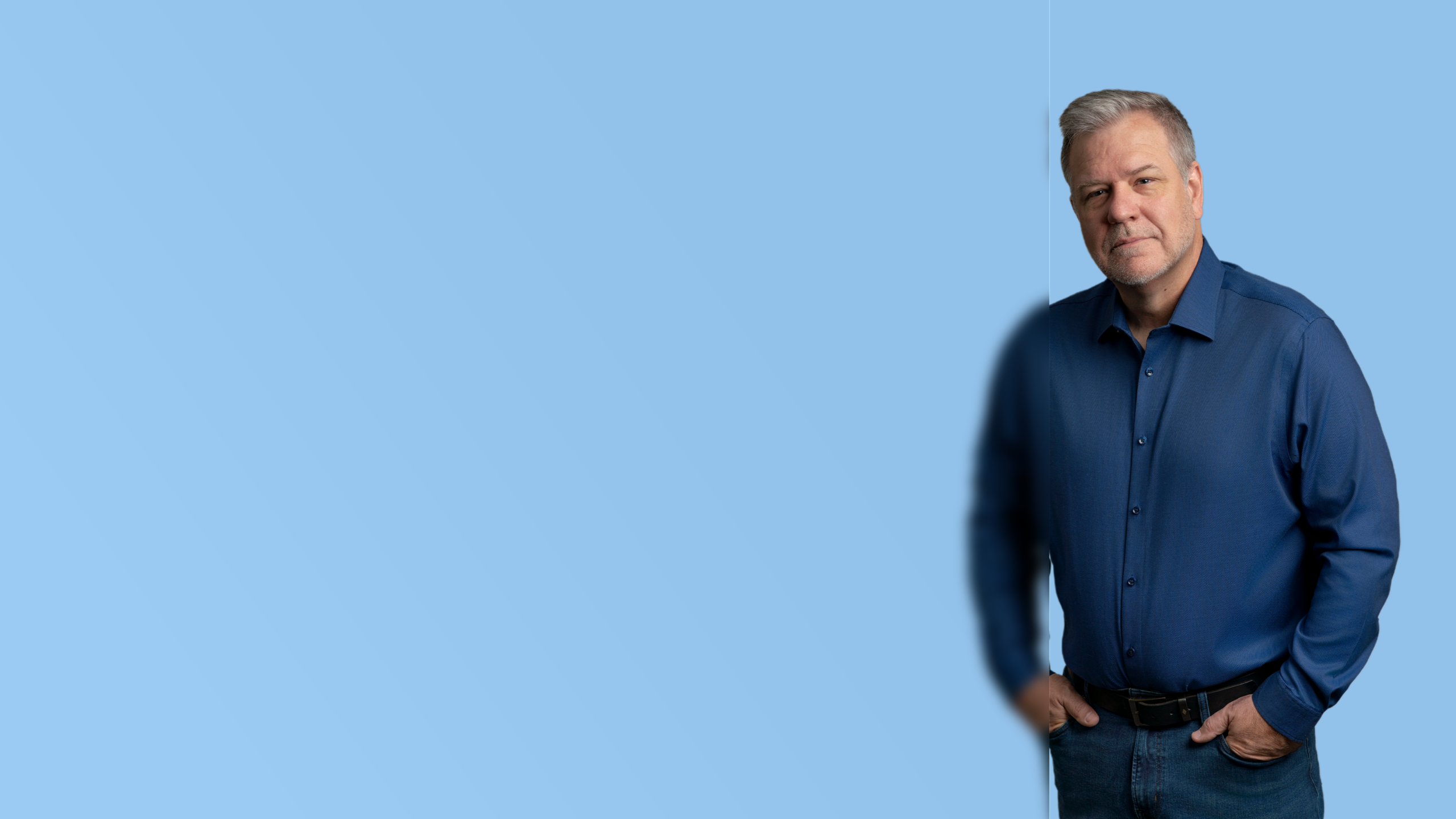 Smiling professional in a blue button-down shirt